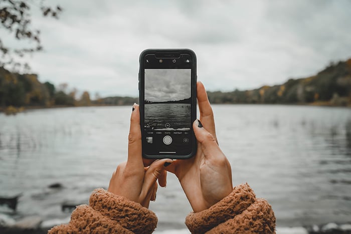 Photo of hands holding an iPhone