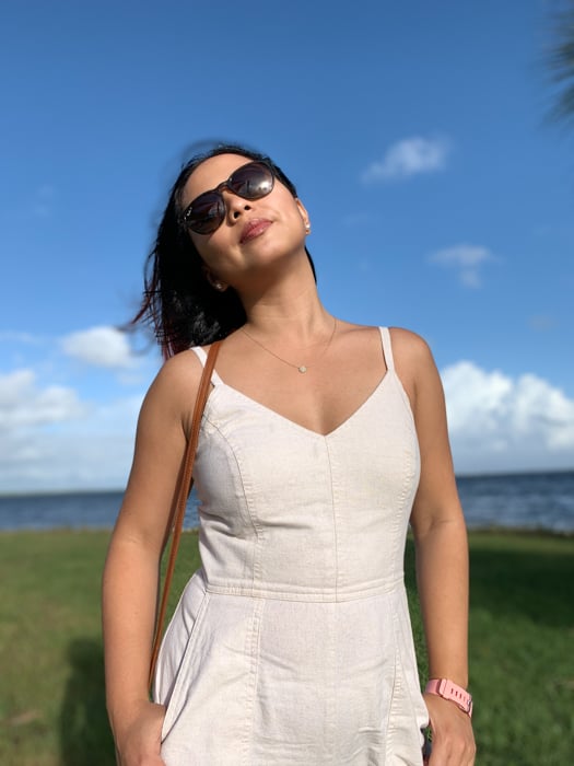 A woman wearing sunglasses basking in the light