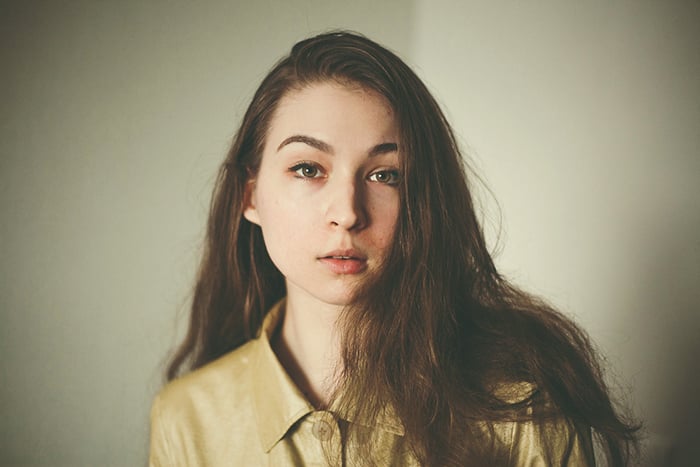 a professional headshot photo of a young woman