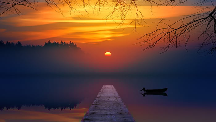A beautiful sunset over a misty lake 