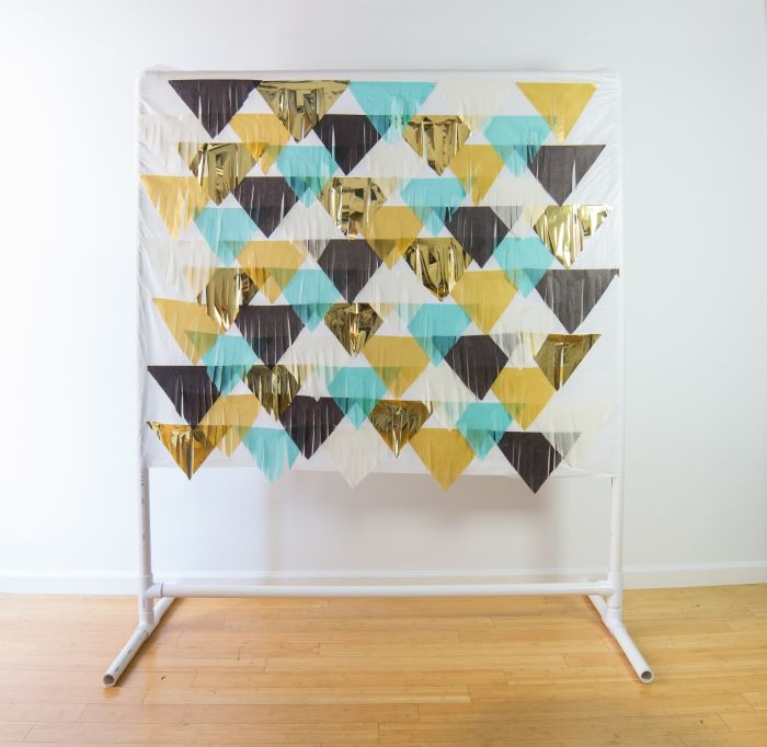 A backdrop stand with a fringed material backdrop