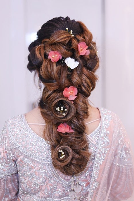 A wedding hair style with flowers and pearls