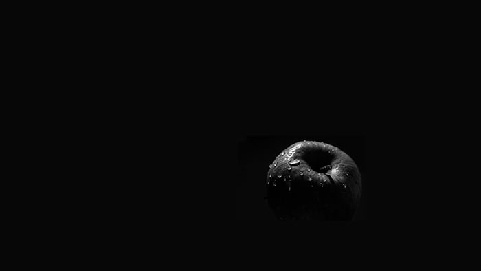 Dark and moody still life of an apple