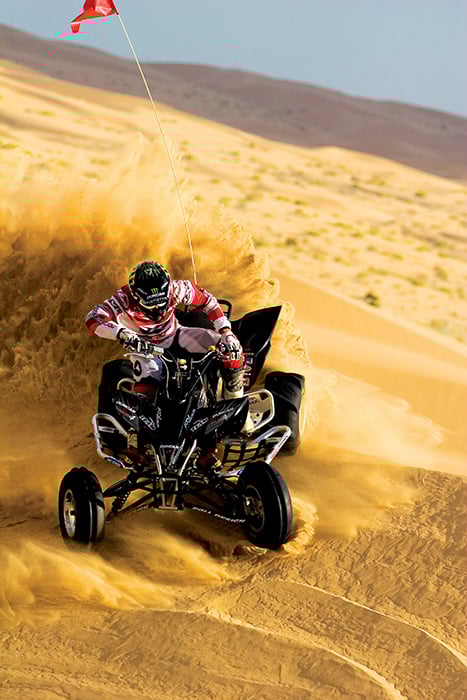 Action shot of a motorsports rider on a beach