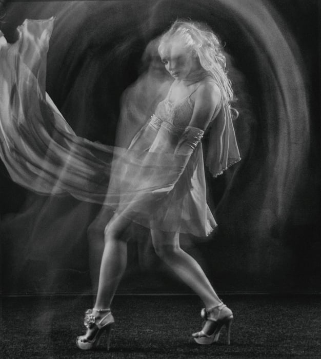Black and white long exposure of a female dancer onstage