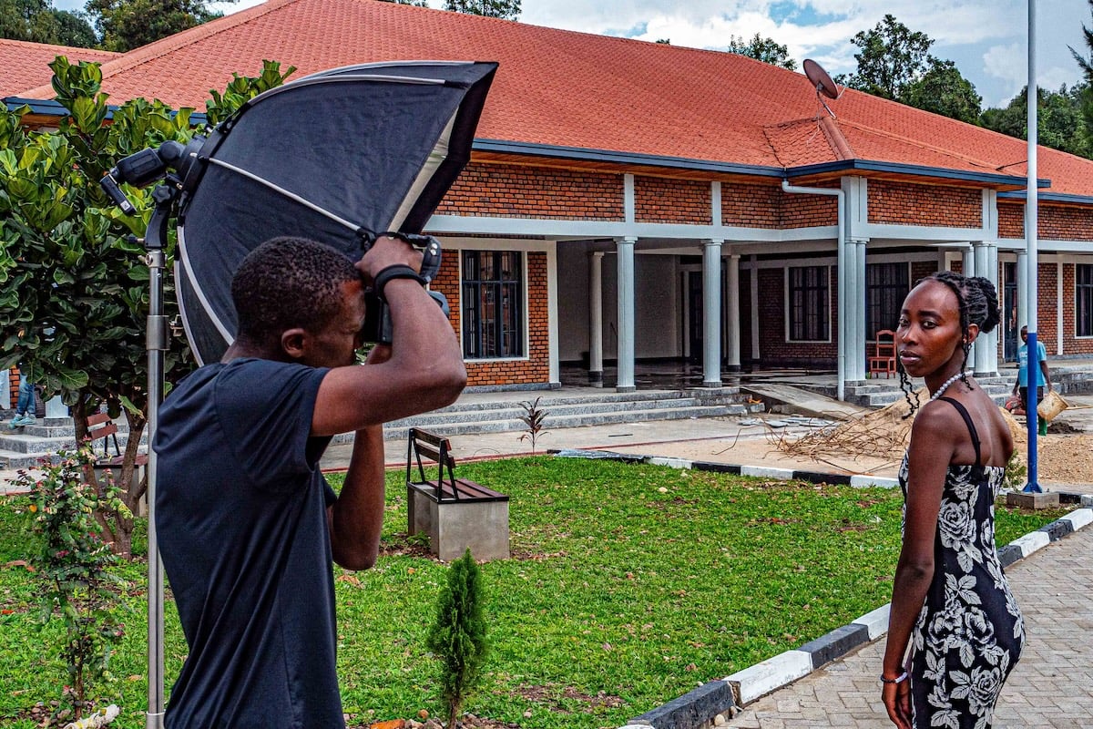 A photographer taking a picture of a model on an outdoor photoshoot