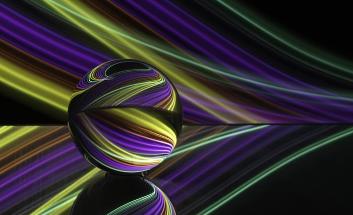 A colorful, abstract, circular pattern with flowing lines behind it.