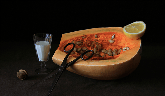 Food still life with melon, a lemon, a scissors and glass of milk