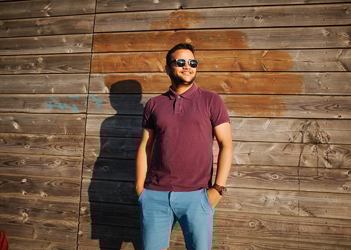 A man posing for a photographer