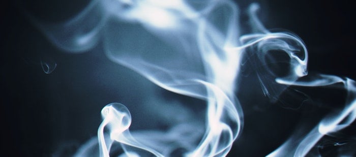 Blue, swirling smoke with a black background.