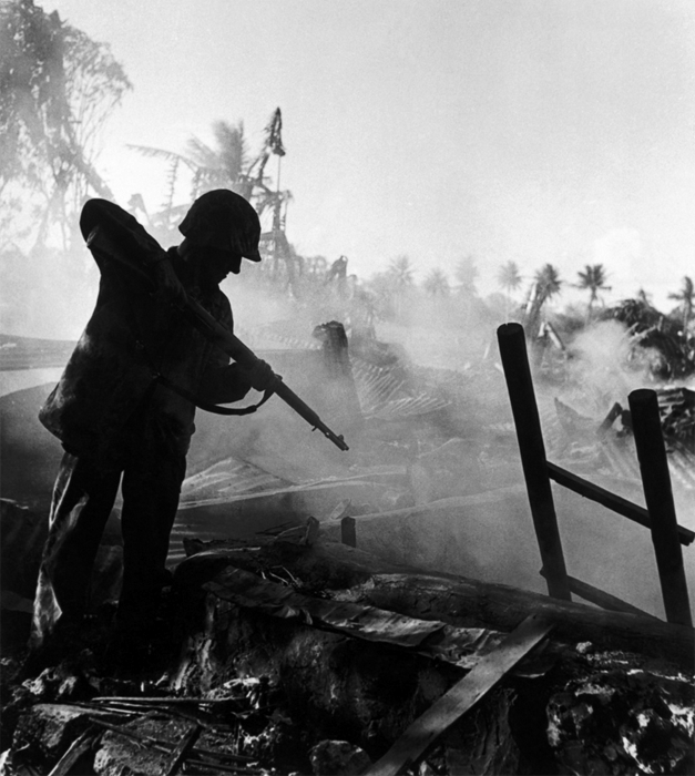A soldier aiming at the ground.