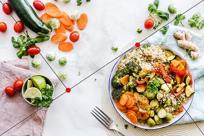 A meal with vegetables presented on plates and bowls. 