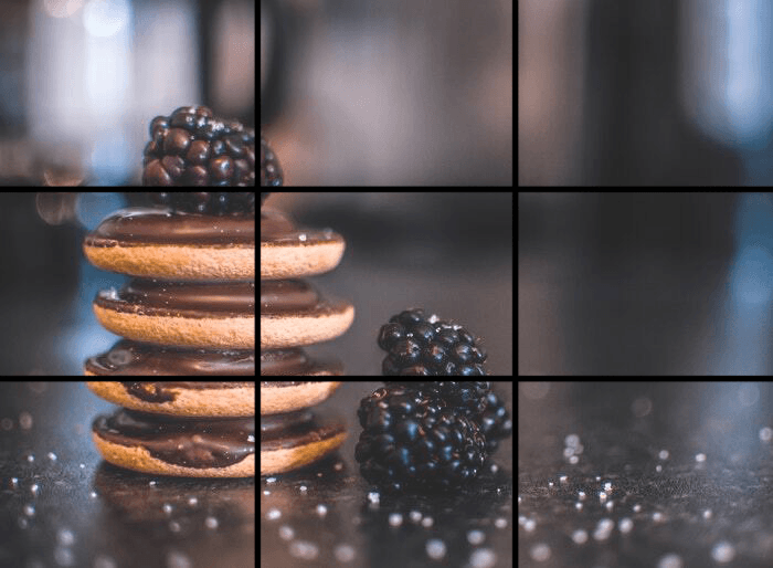 A food item with a caramel drizzle on top, placed atop a stack of round pastries or cookies.