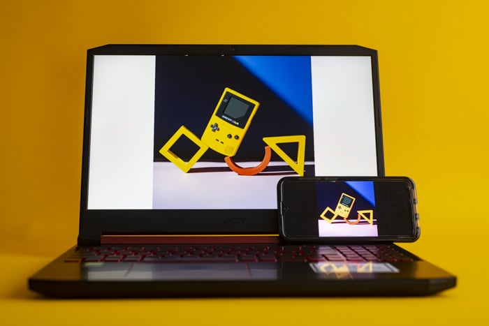 A laptop and phone with the same image on each screen