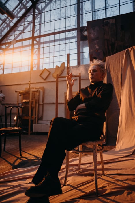 Photo of a man sitting on a chair, smoking