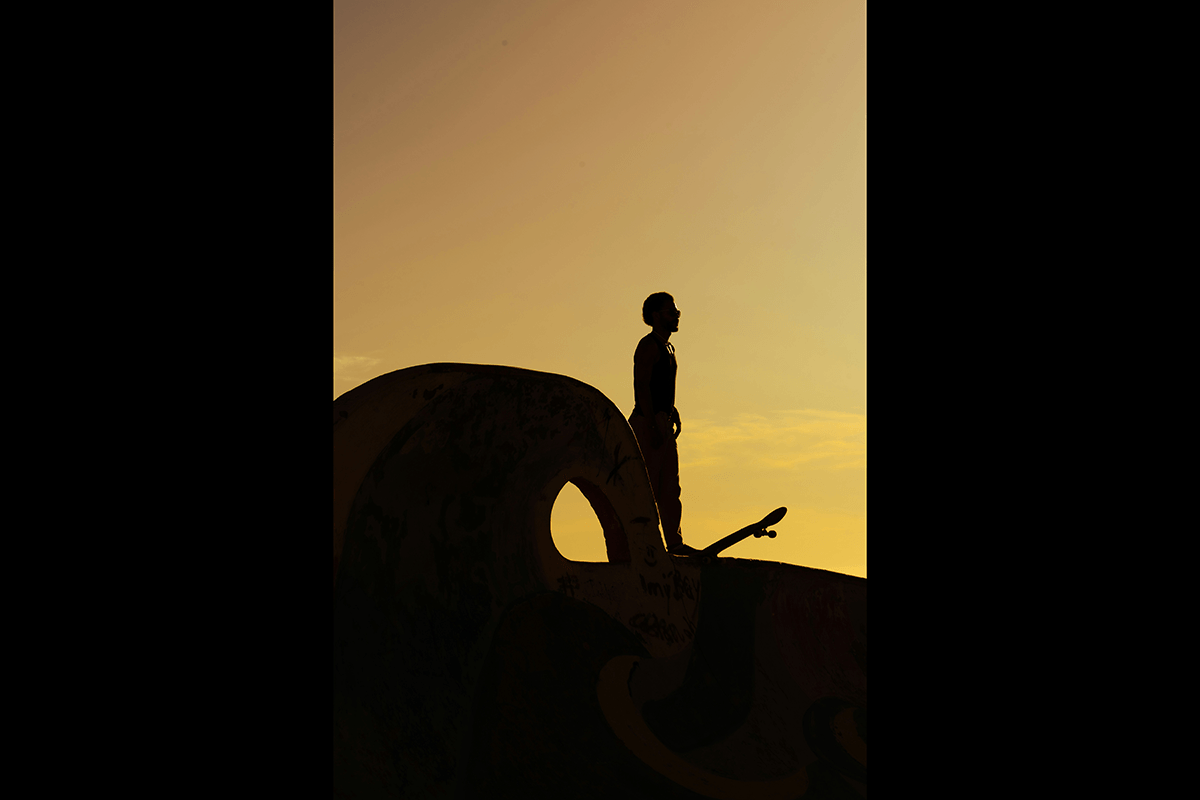 A silhouette of a skateboarder at the top of a ramp as an example of skateboard photography