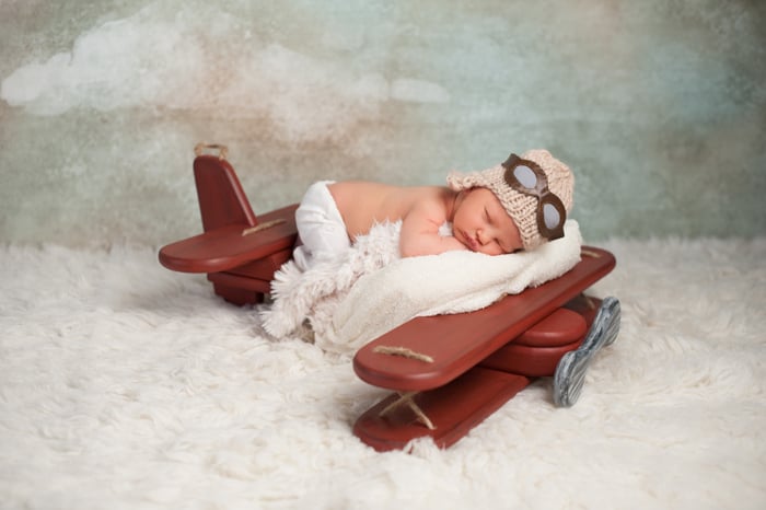 newborn baby posing on an interesting airplane prop