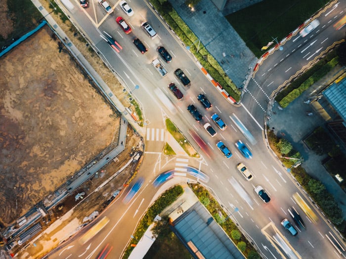 a drone photography image of cars at a busy city intersection