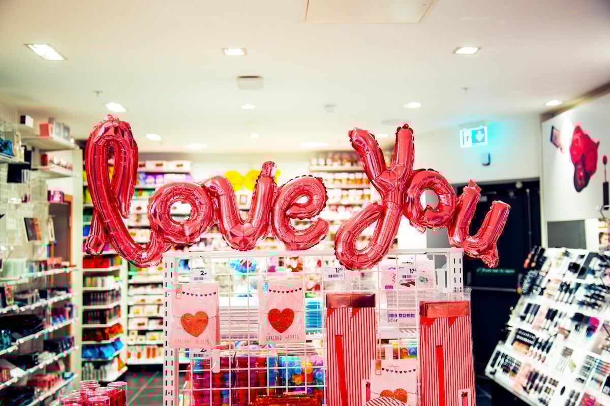Love you balloons in a stationary store as a Valentines Day photoshoot idea