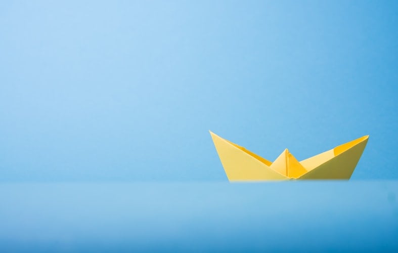 minimalist image of a paper boat
