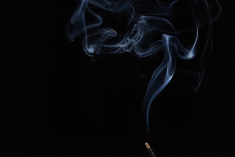 smoke from incense on a black background