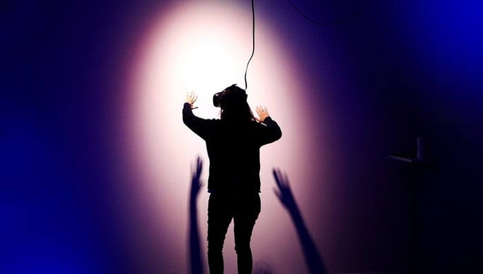 A person performing on a stage with lights.