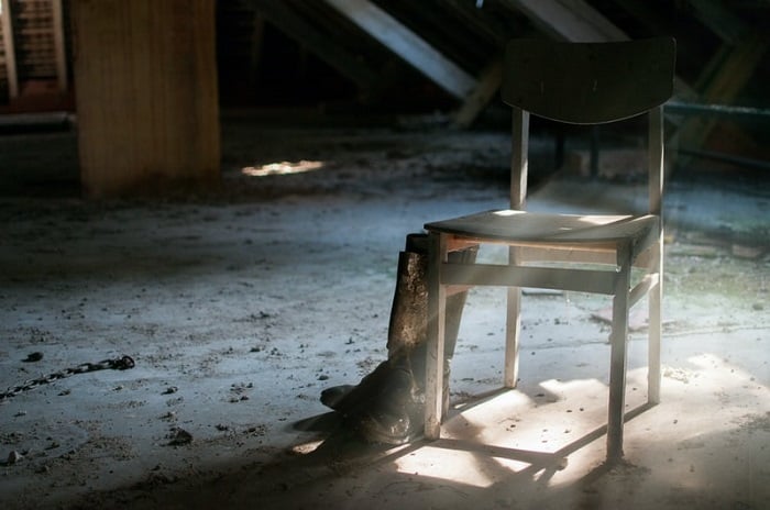 cowboy boots resting against a chair at an undisclosed location