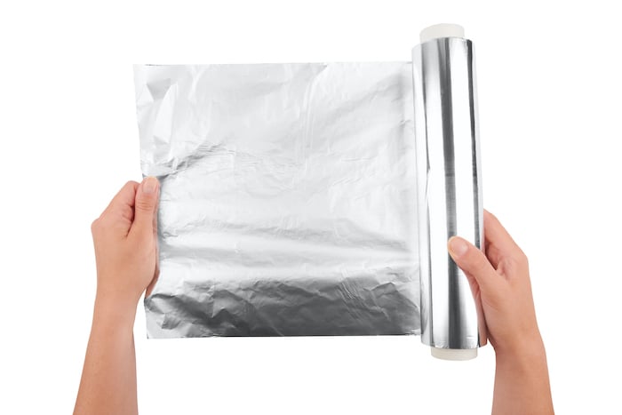 diy light reflector: tinfoil held by woman