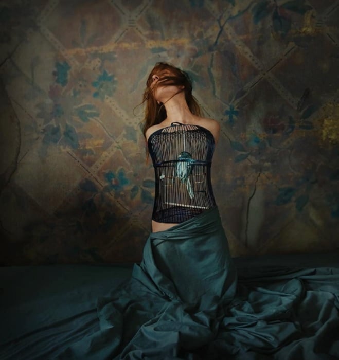 A woman with a birdcage for a chest as an example of surreal photography