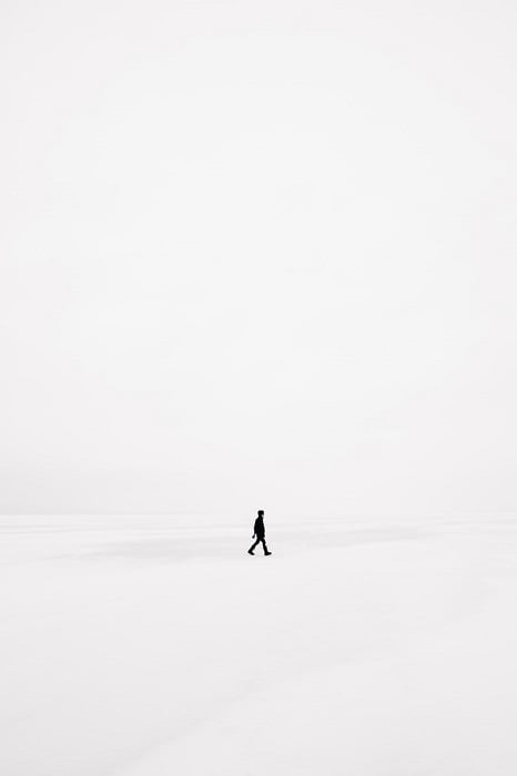 Surreal Photography example of a man walks on pure white landscape