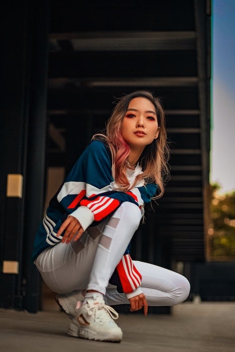 Woman squatting in sportswear as an idea for model poses