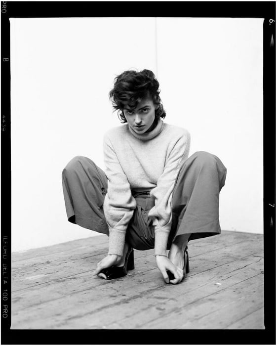 Black and white portrait of woman squatting