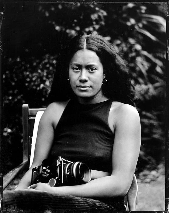 Wet plate photography portrait of woman in chair outside