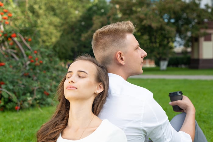 Couple sitting back-to-back