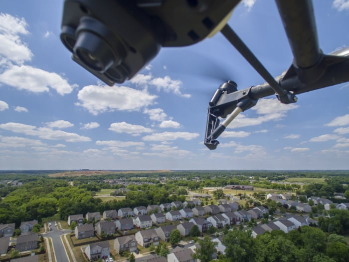 Underside of a drone camera and houses below