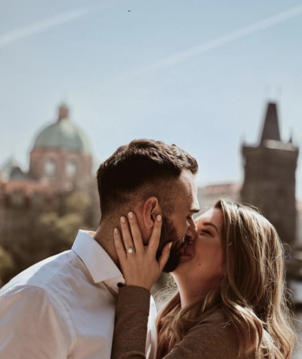 Young couple kissing by Charles Bridge, Prague Young couple kissing by Charles Bridge, Prague