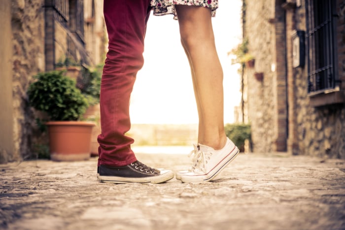 Picture of a couple standing face to face, but only their legs and feet are visible Picture of a couple standing face to face, but only their legs and feet are visible