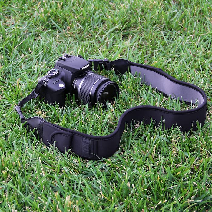 Amazon.com product page TrueSHOT camera strap and Canon DSLR camera in grass