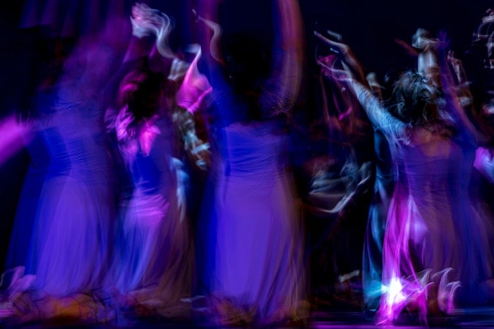 Blurred dancers on a stage.