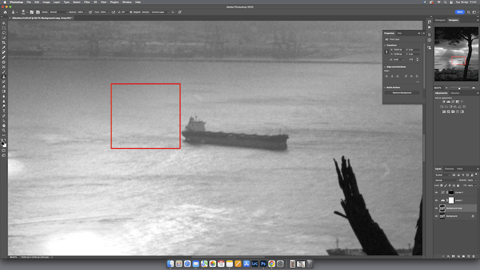 A ship in the foreground and a bridge or dock in the background.