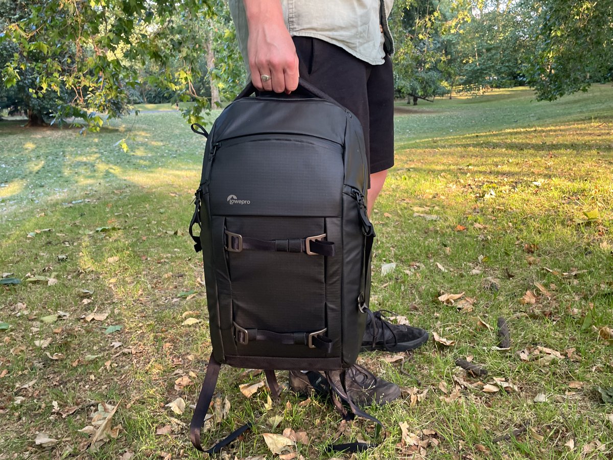 Using the top handle of the Lowepro Freeline BP 350 AW camera backpack