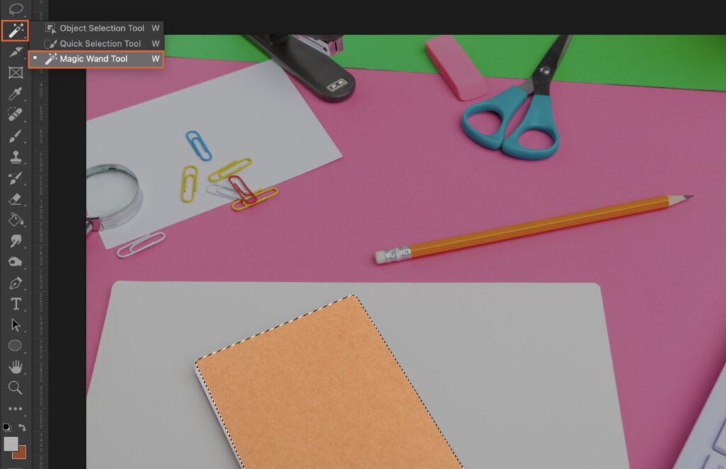 Graphic design tools, materials, and a partially completed project. 