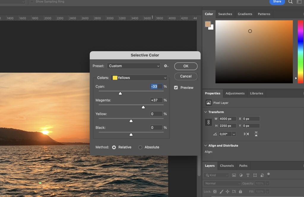 A photo editing software with a sunset picture, where the user has selected a color and is setting its properties in the toolbar.