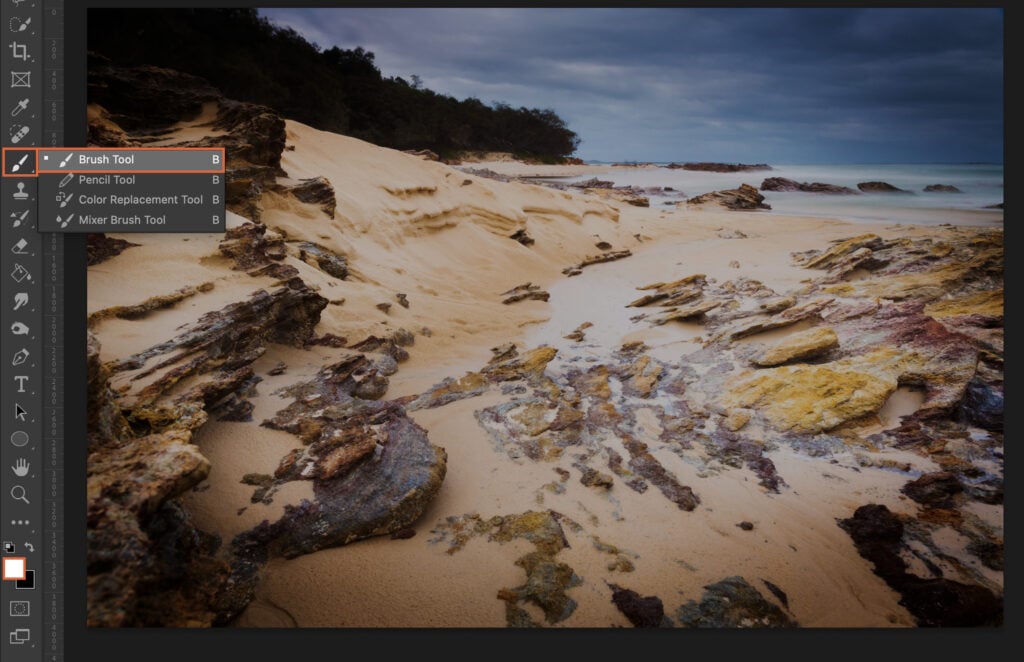 An image editing software displaying a beach scene with a digital toolbox.