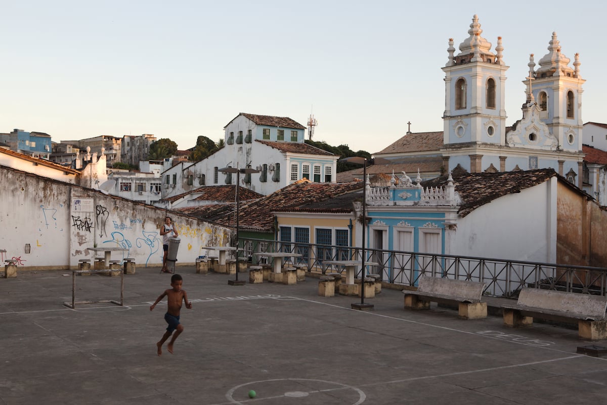 Image of boy playing in a courtyard beside a church after being processed in AfterShot Pro 3