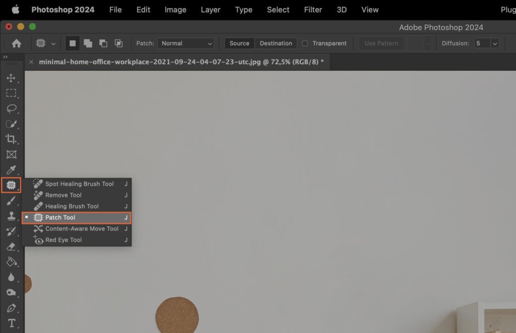 Adobe Photoshop open, showing a white background and an icon of a camera at the bottom right.