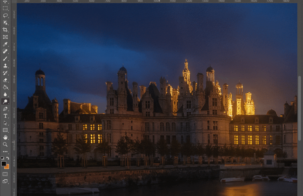 A grand palace at night, with the moon and stars in the sky.