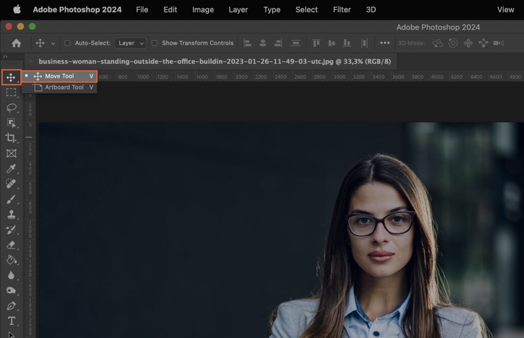 A woman with glasses, set against a grey background and overlaid with a computer interface for photo editing software. 