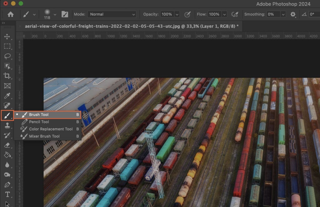 A graphic design software with an open image featuring a freight terminal scene.
