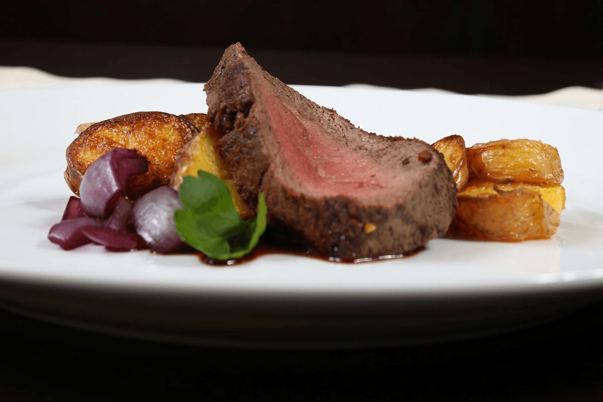 A stylish photo of a beef and vegetable dish